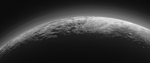 Just 15 minutes after its closest approach to Pluto on July 14, 2015, NASA's New Horizons spacecraft looked back toward the sun and captured this near-sunset view of the rugged, icy mountains and flat ice plains extending to Pluto's horizon. The smooth expanse of the informally named icy plain Sputnik Planum (right) is flanked to the west (left) by rugged mountains up to 11,000 feet (3,500 meters) high, including the informally named Norgay Montes in the foreground and Hillary Montes on the skyline. To the right, east of Sputnik, rougher terrain is cut by apparent glaciers. The backlighting highlights more than a dozen layers of haze in Pluto’s tenuous but distended atmosphere. The image was taken from a distance of 11,000 miles (18,000 kilometers) to Pluto; the scene is 780 miles (1,250 kilometers) wide. Crédit: NASA/Johns Hopkins University Applied Physics Laboratory/Southwest Research Institute