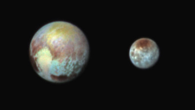 Pluto and Charon in False Color Show Compositional Diversity

This July 13, 2015, image of Pluto and Charon is presented in false colors to make differences in surface material and features easy to see. It was obtained by the Ralph instrument on NASA's New Horizons spacecraft, using three filters to obtain color information, which is exaggerated in the image. These are not the actual colors of Pluto and Charon, and the apparent distance between the two bodies has been reduced for this side-by-side view.

The image reveals that the bright heart-shaped region of Pluto includes areas that differ in color characteristics. The western lobe, shaped like an ice-cream cone, appears peach color in this image. A mottled area on the right (east) appears bluish. Even within Pluto's northern polar cap, in the upper part of the image, various shades of yellow-orange indicate subtle compositional differences.

The surface of Charon is viewed using the same exaggerated color. The red on the dark northern polar cap of Charon is attributed to hydrocarbon materials including a class of chemical compounds called tholins. The mottled colors at lower latitudes point to the diversity of terrains on Charon.

This image was taken at 3:38 a.m. EDT on July 13, one day before New Horizons’ closest approach to Pluto.

NASA/Johns Hopkins University Applied Physics Laboratory/Southwest Research Institute